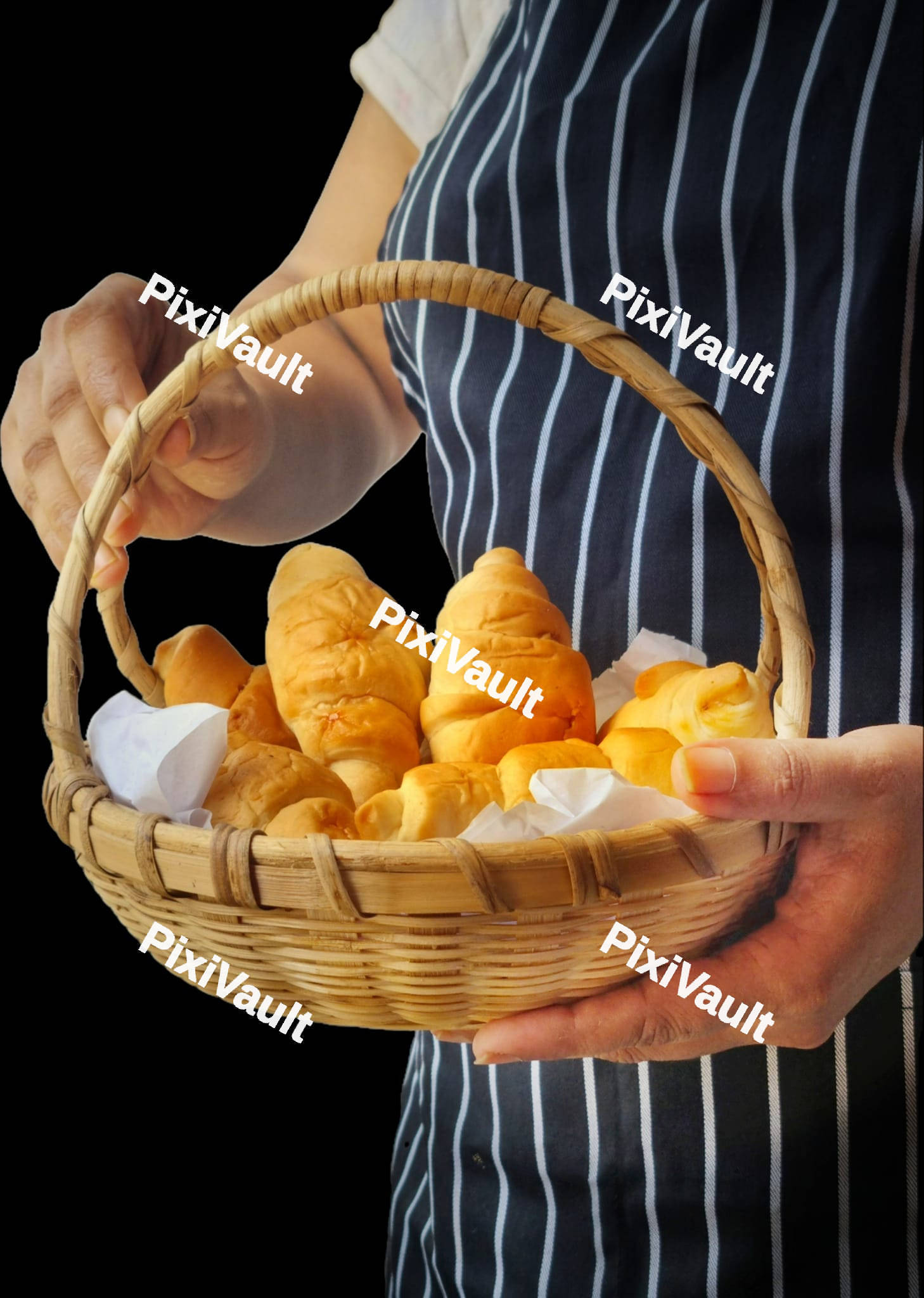 A person holding a basket with croissants